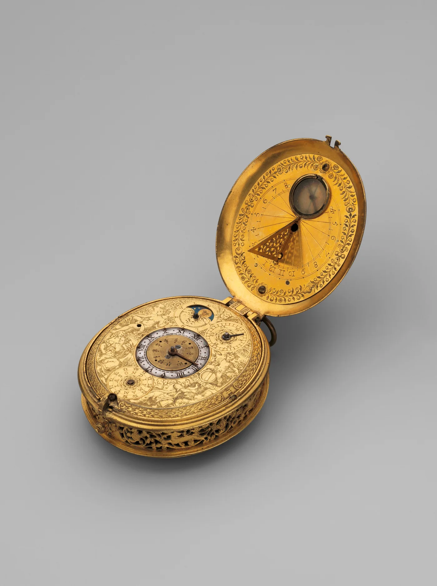 An open gilt pocket watch from around 1605 with an engraved astronomical dial, moon-phase indicator, and a fold-out sundial set into the lid